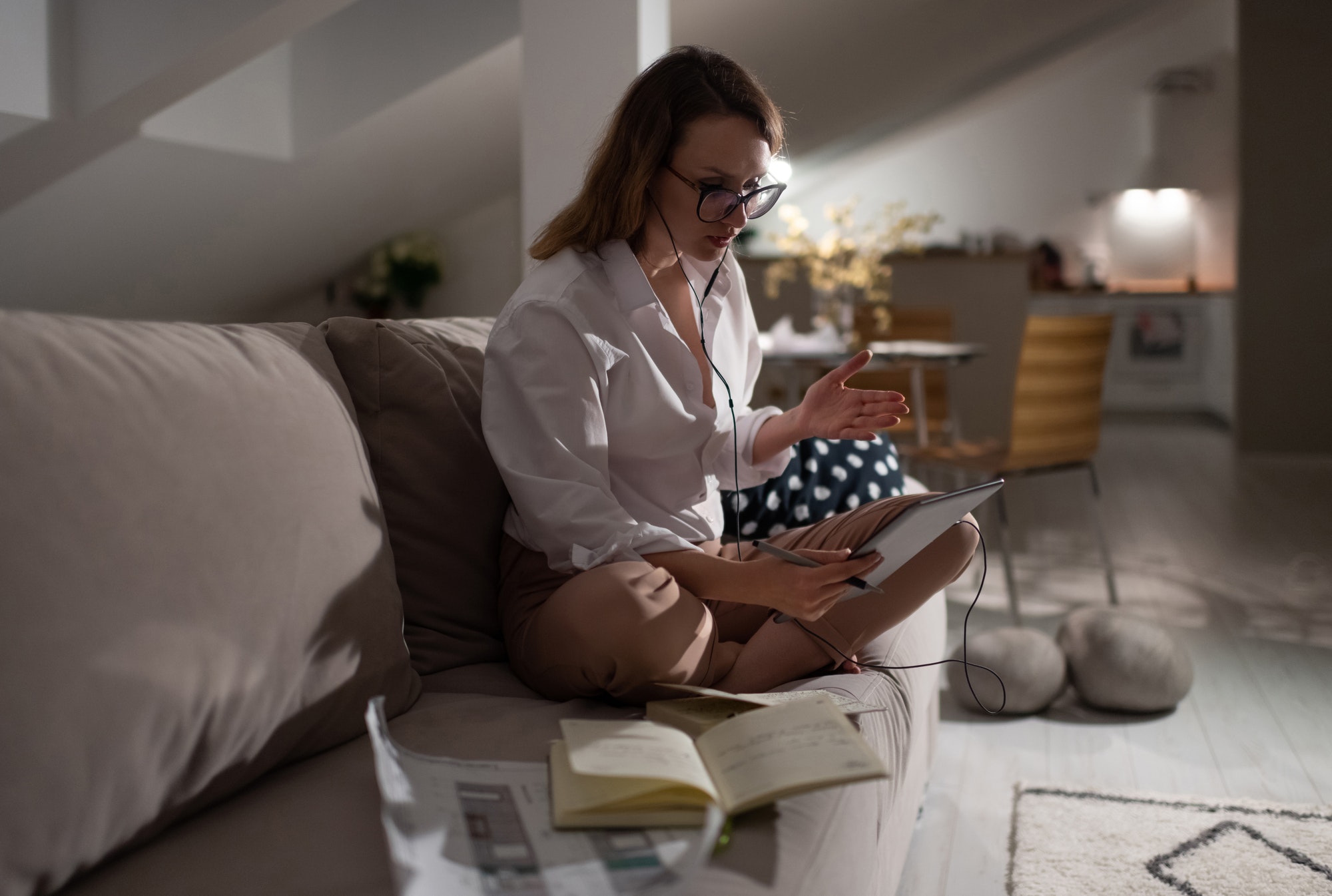 Modern businesswoman communicating with employees during video conference