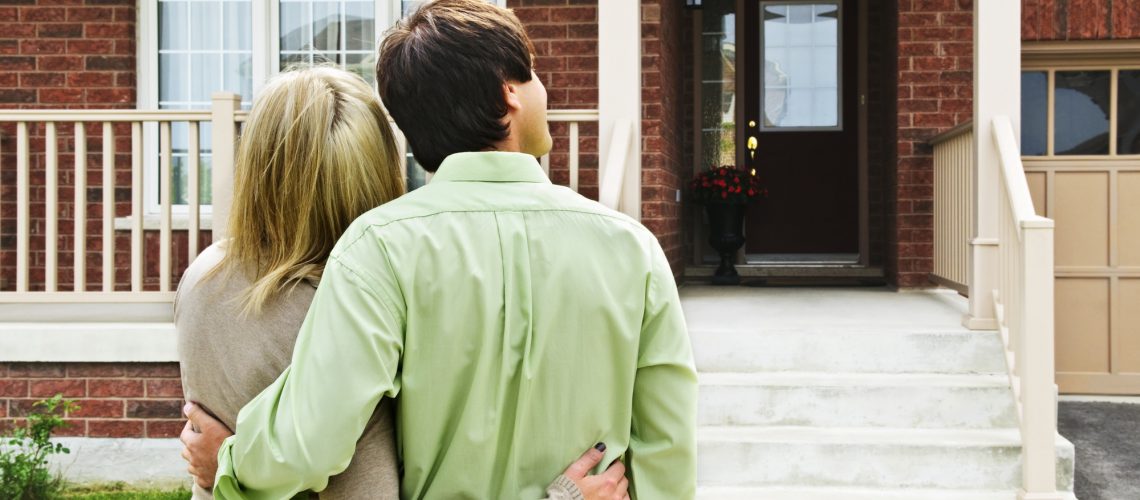 Young happy couple shopping for new home